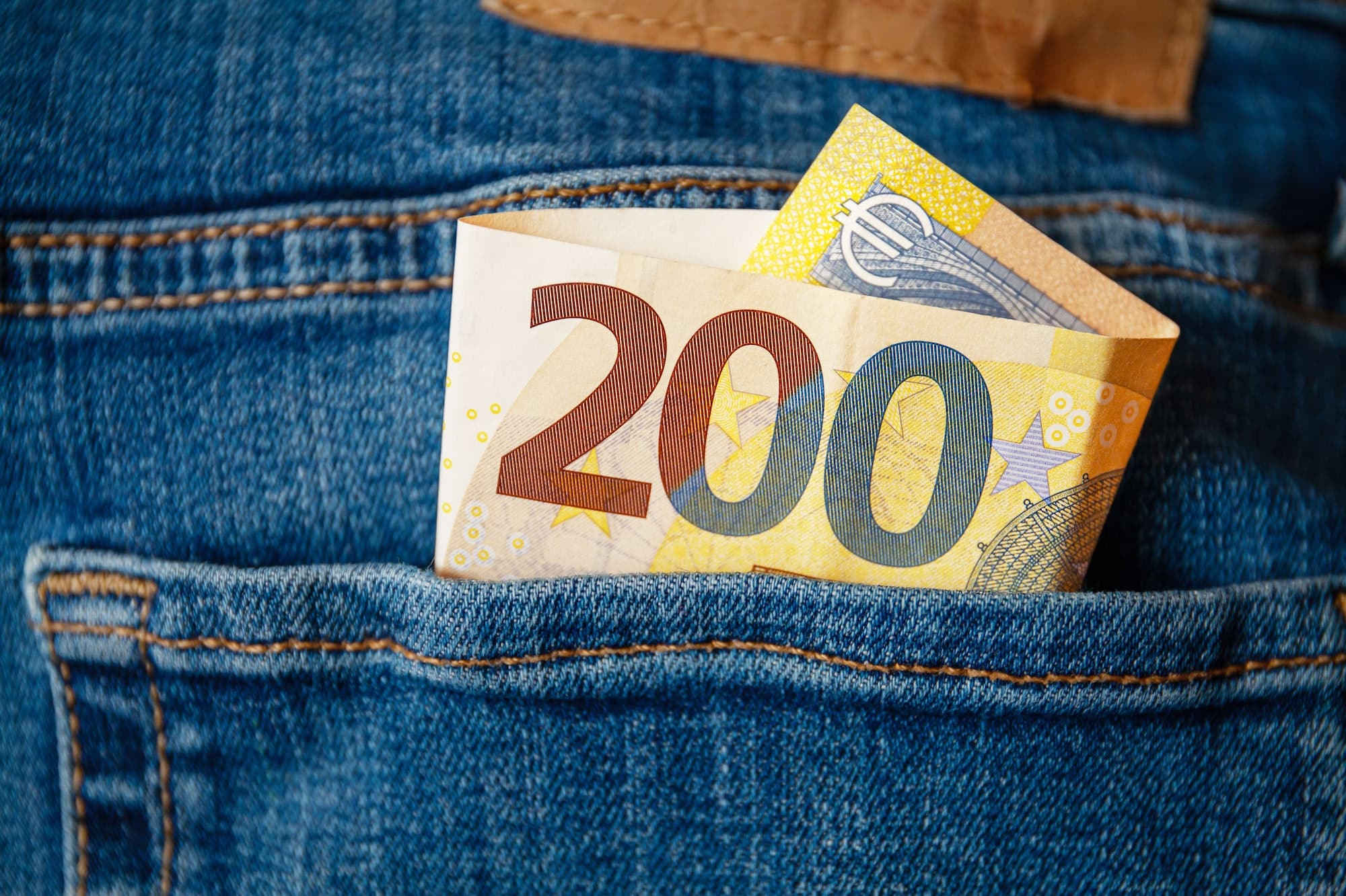 A 200 Euro banknote in the pocket. Concept about investments, earnings, cash, profits, wealth